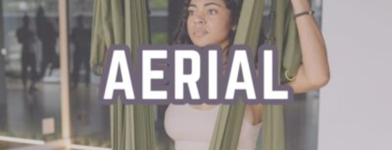 Aerial yoga poses woman in silk hammock yoga swing studio practice.